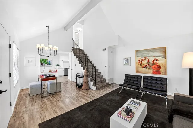 a living room with furniture and a chandelier