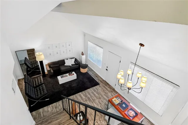 a view of a workspace with furniture and wooden floor