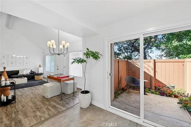 a very nice looking room with a large window and chandelier