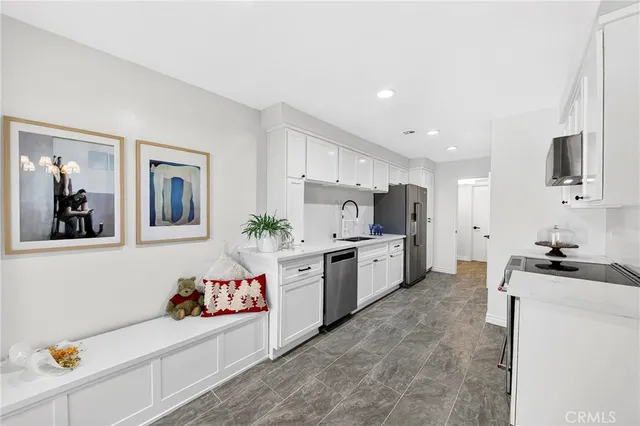 a kitchen with granite countertop a sink and cabinets