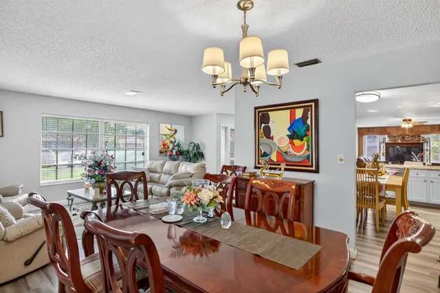 a kitchen with a table chairs microwave and cabinets