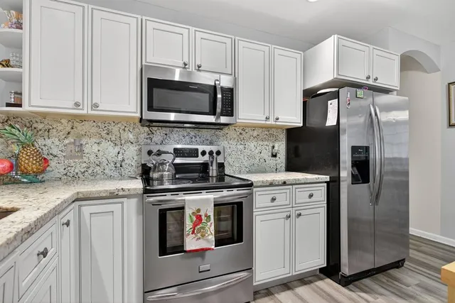 a living room with furniture a dining table and kitchen view