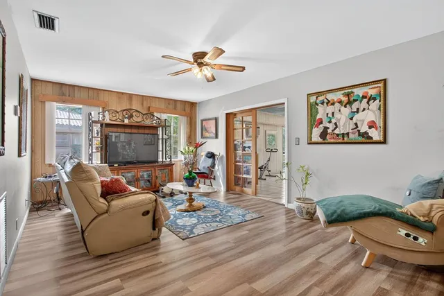 a living room with furniture a rug and a large window
