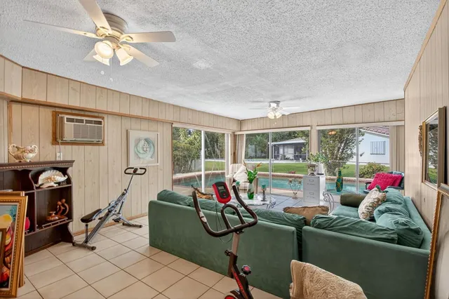 a living room with furniture and ceiling fan