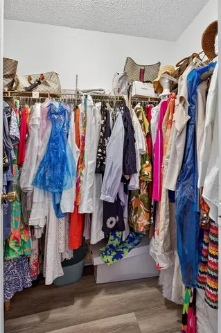 a bedroom with a bed and a flat tv screen on dresser