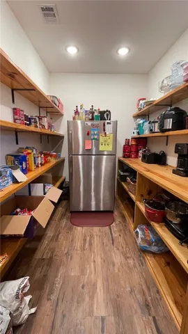 a kitchen with a sink and wooden floor
