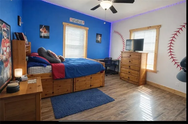 a bedroom with a bed and a chandelier