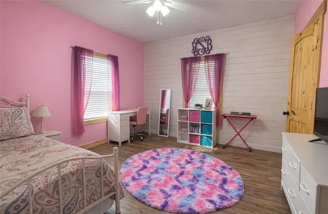 a bathroom with a granite countertop sink toilet and a mirror