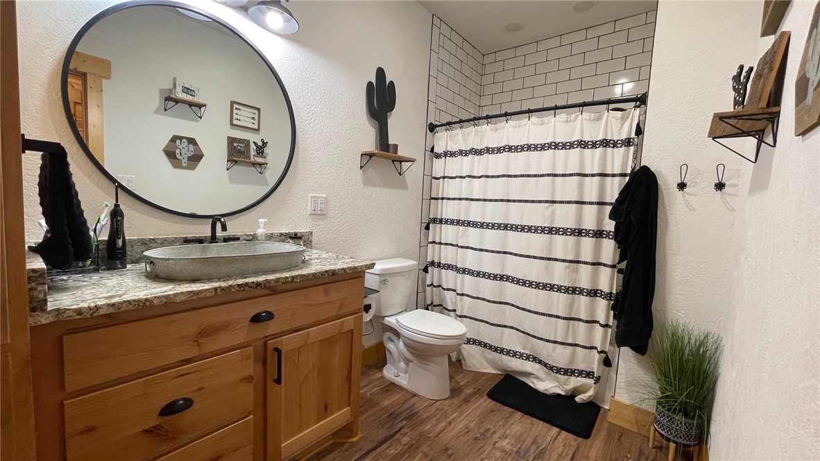 13541 East Us Highway Gause, TX 77857 - Photo 20 of 39 a bathroom with a granite countertop sink toilet and a mirror