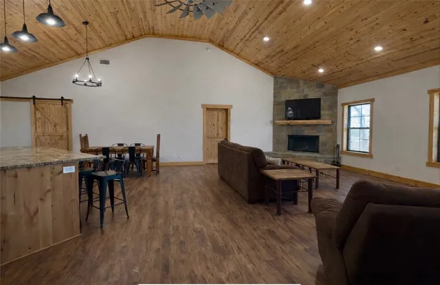 a living room with furniture a wooden floor and a chandelier