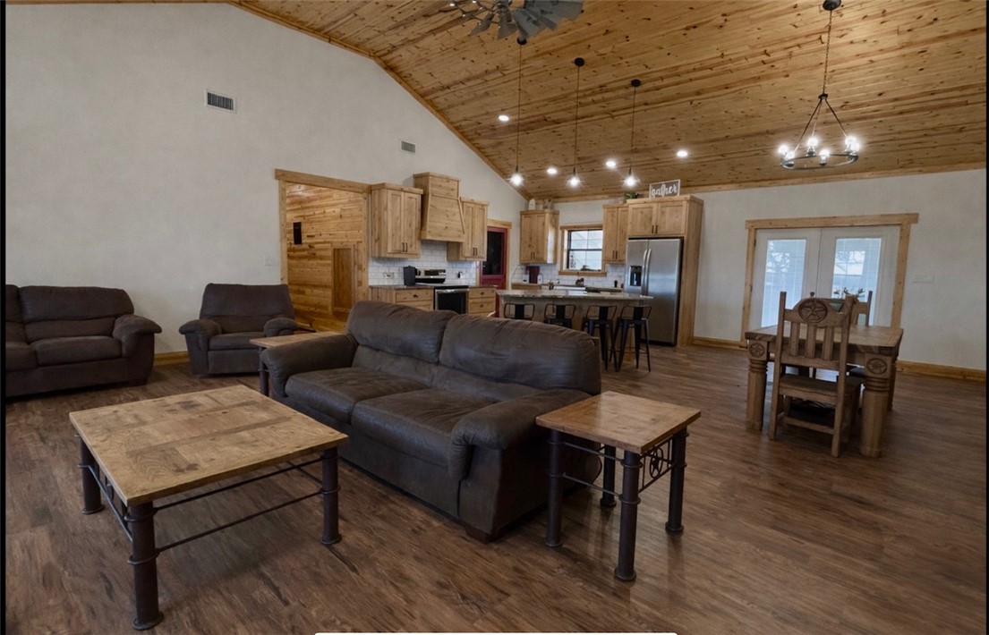 13541 East Us Highway Gause, TX 77857 - Photo 9 of 39 a living room with furniture a wooden floor and a chandelier