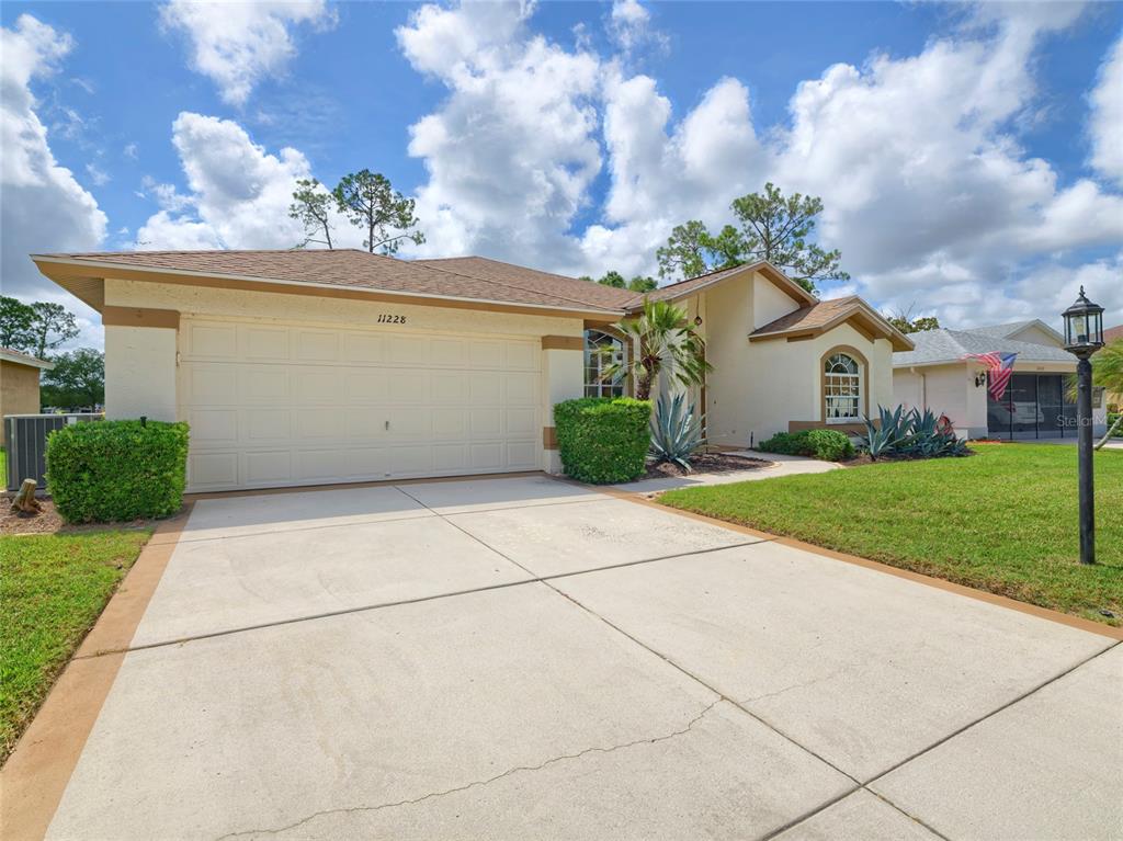 11228 Windrush Circle Hudson, FL 34667 - Photo 43 of 67 a view of house and garden