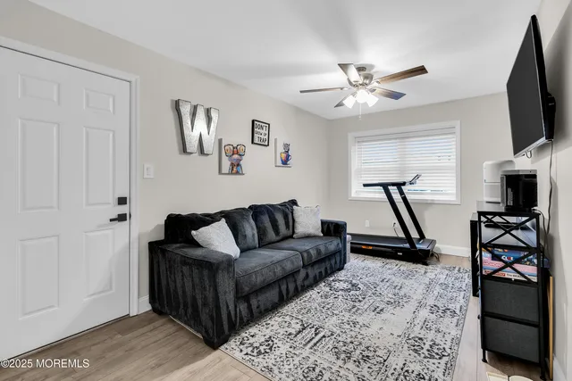 a living room with furniture a flat screen tv and a rug