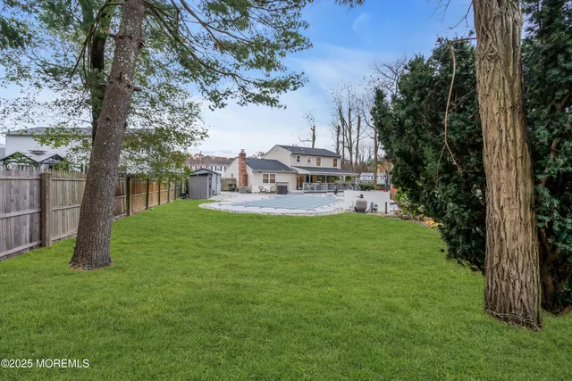 a view of a white house with a yard