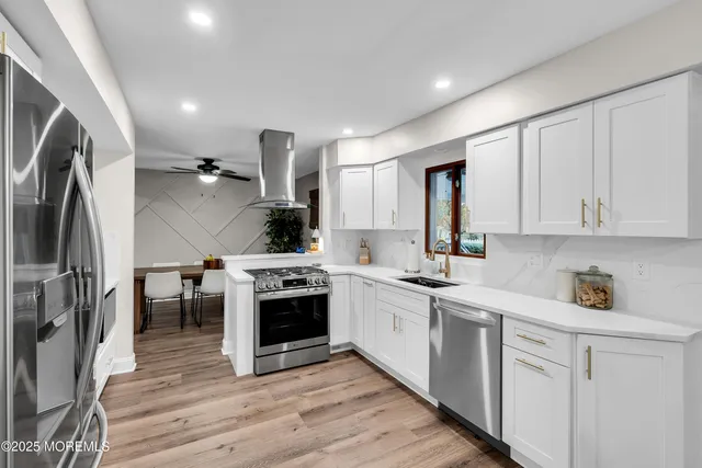 a kitchen with cabinets and stainless steel appliances
