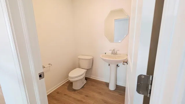a bathroom with a sink toilet and a mirror