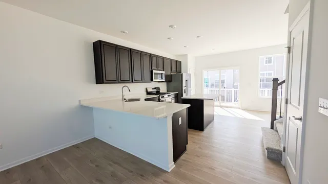 a kitchen with a refrigerator and a stove top oven