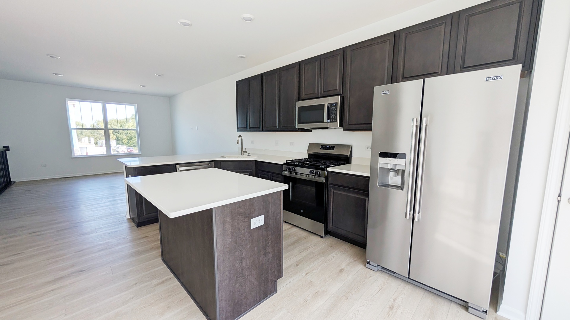 527 Red Oak Circle, Unit 2202 Volo, IL 60020 - Photo 3 of 17 a kitchen with stainless steel appliances a refrigerator stove microwave and sink
