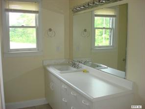 104 Huffstetler Lake Road Dallas, NC 28034 - Photo 15 of 16 a bathroom with a granite countertop sink a toilet and with a window
