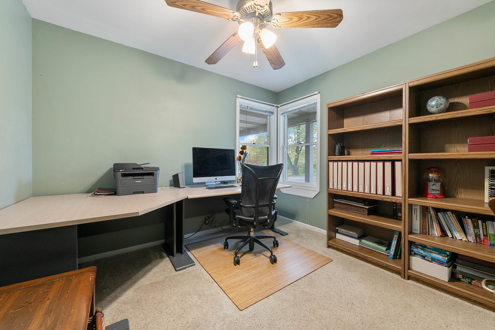 28W151 Garys Mill Road Winfield, IL 60190 - Photo 15 of 37 a view of a workspace with furniture and a bookshelf
