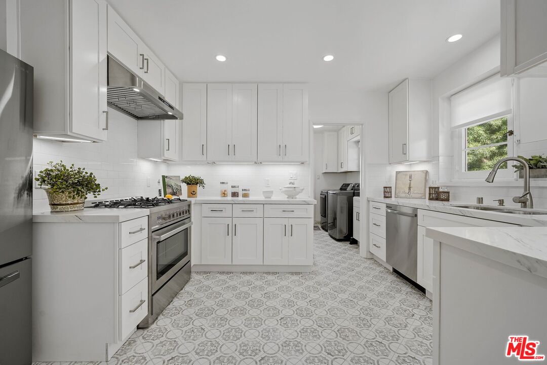 355 21st Place Santa Monica, CA 90402 - Photo 6 of 16 a kitchen with a stove sink and cabinets