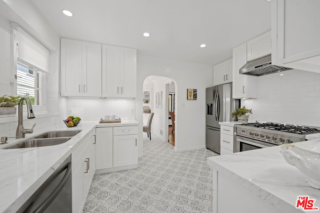 355 21st Place Santa Monica, CA 90402 - Photo 7 of 16 a kitchen with white cabinets and stainless steel appliances