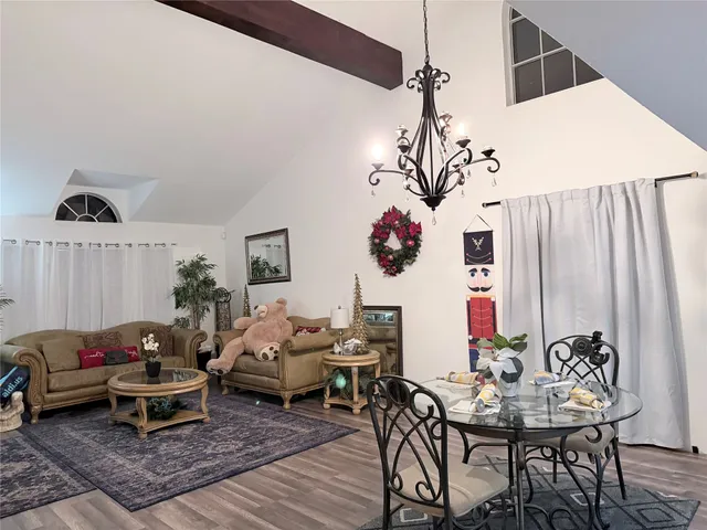 a living room with furniture and a chandelier