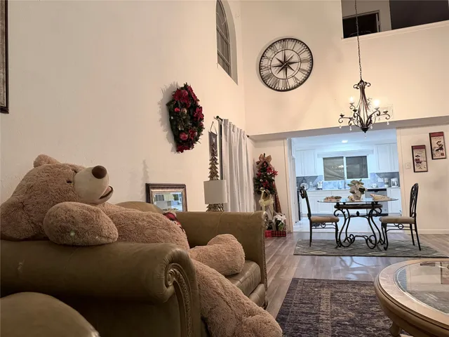 a living room with furniture a clock and a large window