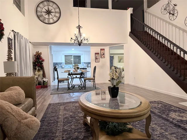 a living room with furniture a clock and a table