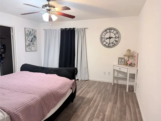 a bedroom with a bed and a lamp on dresser