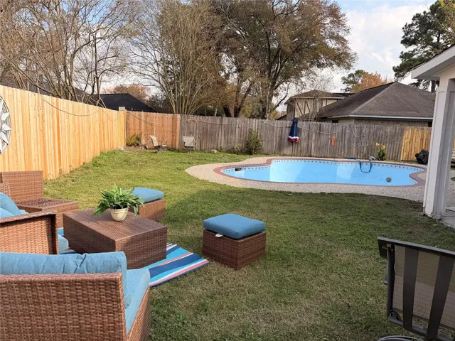 a view of a backyard with swimming pool