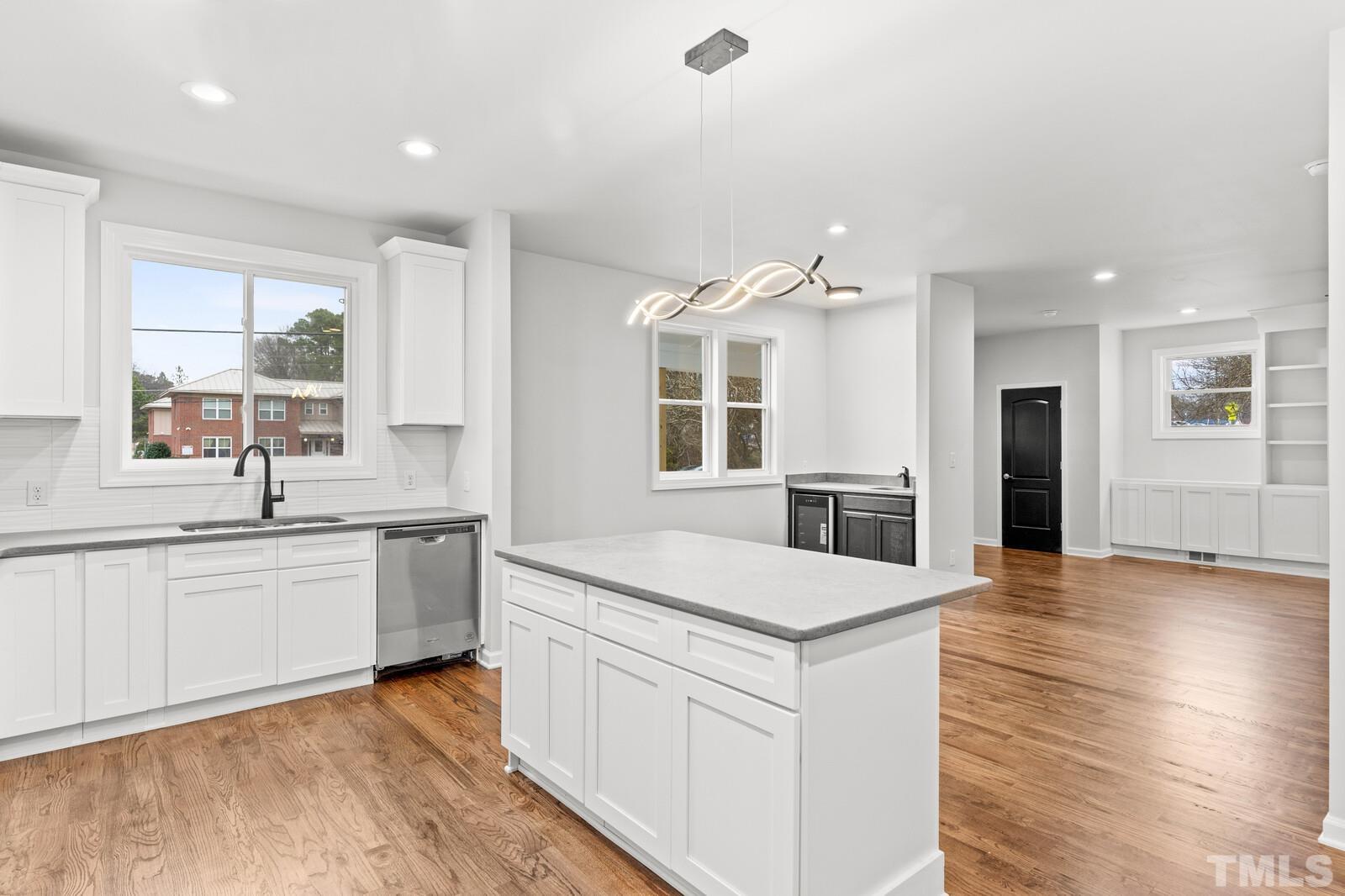 1808 Poole Road Raleigh, NC 27610 - Photo 15 of 35 a large kitchen with stainless steel appliances granite countertop a large counter top and a wooden floors