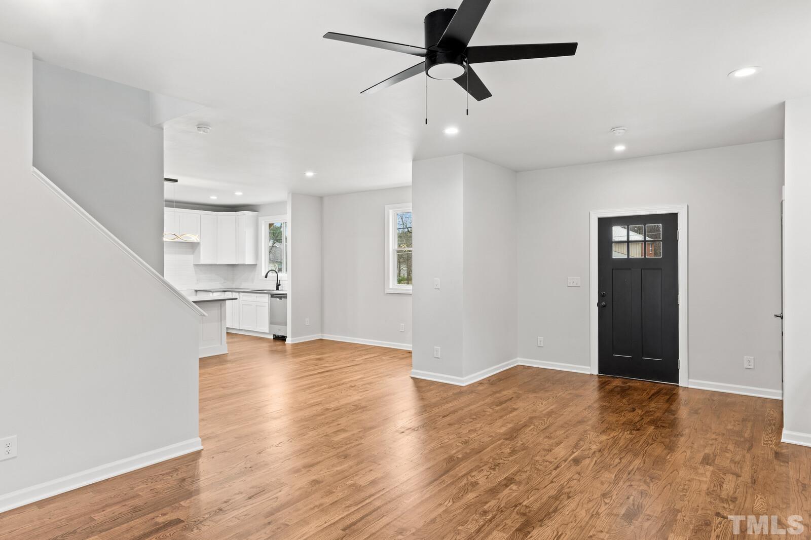 1808 Poole Road Raleigh, NC 27610 - Photo 10 of 35 a view of empty room with wooden floor and ceiling fan