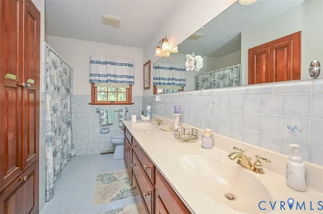 a bathroom with a sink double vanity and a mirror