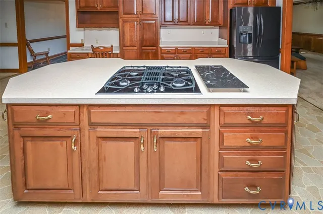 a kitchen with wooden cabinets and a stove top oven