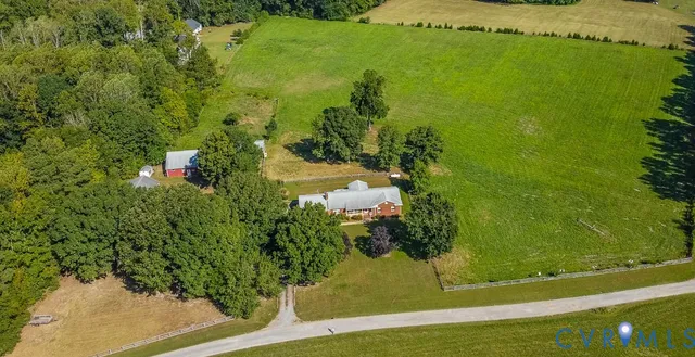 a backyard of a house with lots of green space and fountain