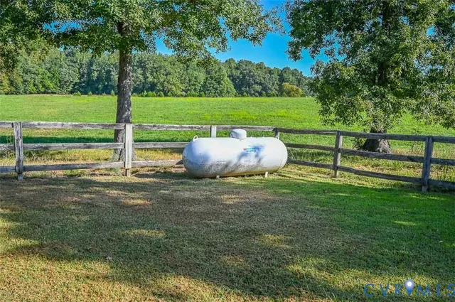 an aerial view of a house with a yard and lake view