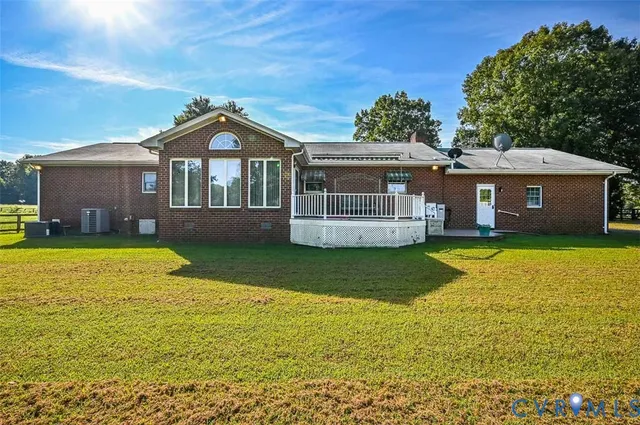 a view of swimming pool with deck and plants