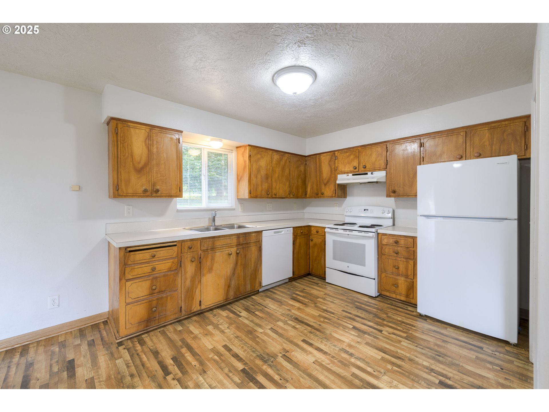29630 Southeast Wheeler Road Boring, OR 97009 - Photo 30 of 46 a kitchen with stainless steel appliances granite countertop a refrigerator a sink dishwasher a stove with wooden cabinets