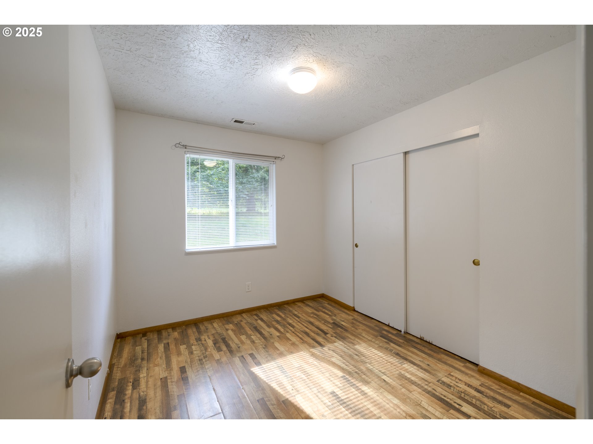 29630 Southeast Wheeler Road Boring, OR 97009 - Photo 31 of 46 a view of an empty room with wooden floor and a window