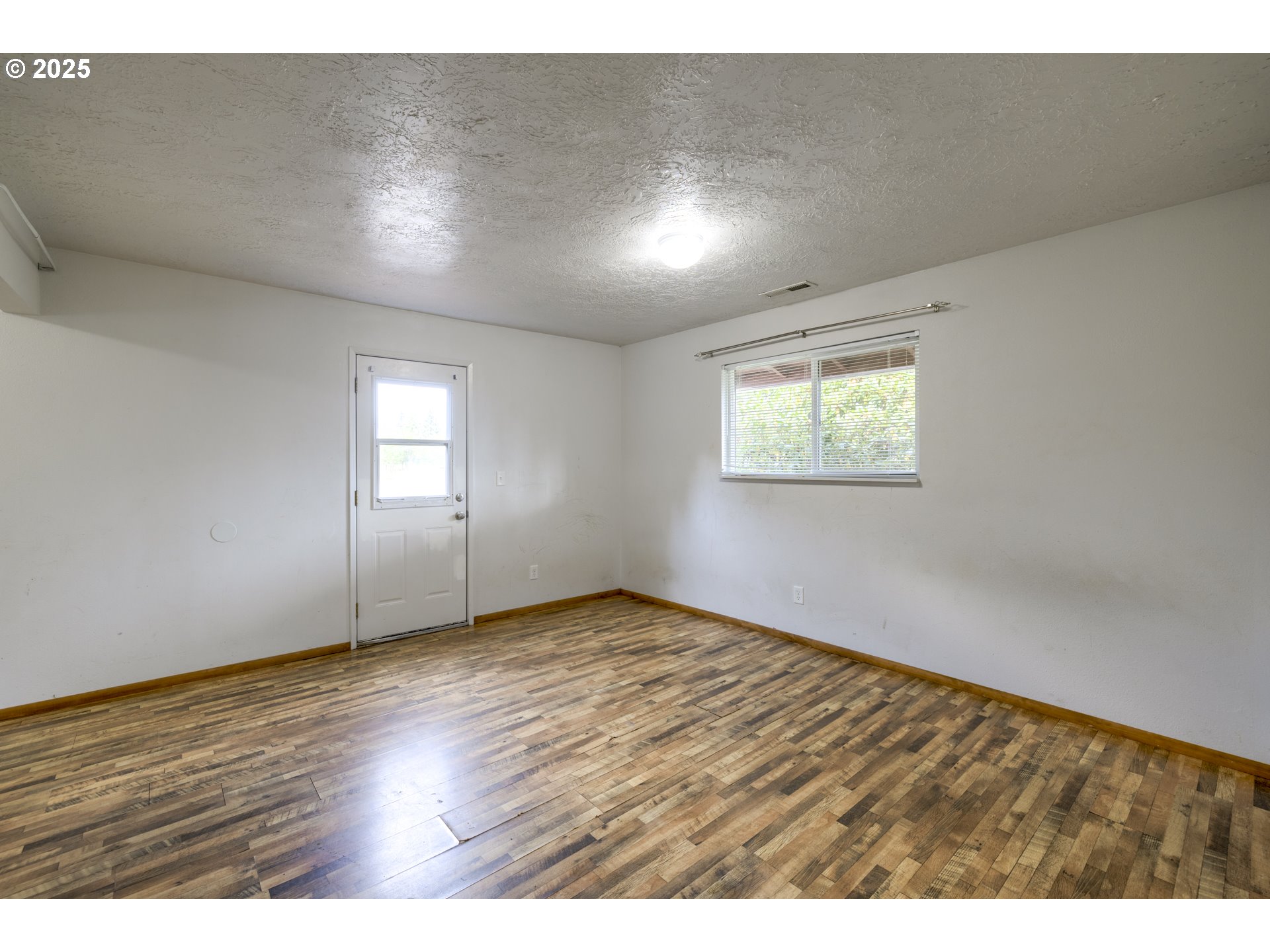 29630 Southeast Wheeler Road Boring, OR 97009 - Photo 33 of 46 an empty room with wooden floor and windows