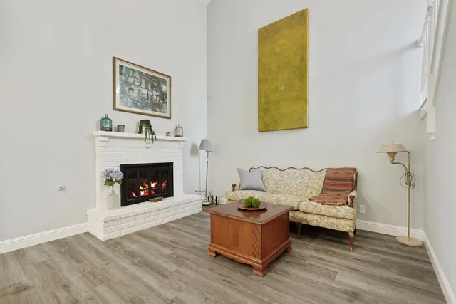 a living room with furniture and a fireplace