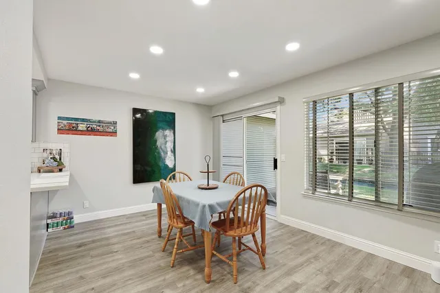 a view of a dining room with furniture window and wooden floor