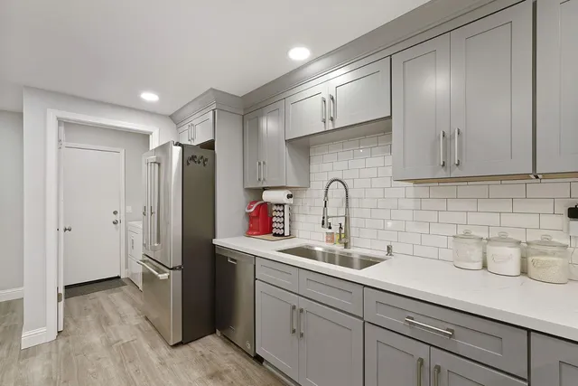 a kitchen with stainless steel appliances a refrigerator and sink