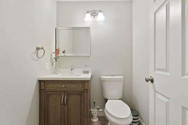 a bathroom with a toilet a sink and mirror