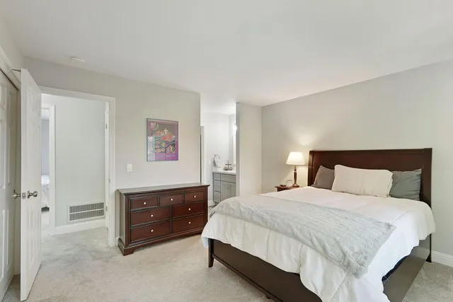 a spacious bedroom with a bed and a large window