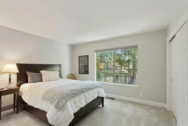 a bedroom with a large bed and a window