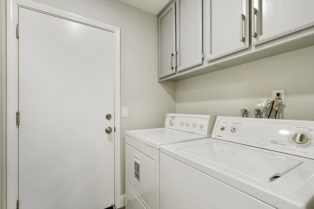 a bedroom with a bed and a lamp on dresser