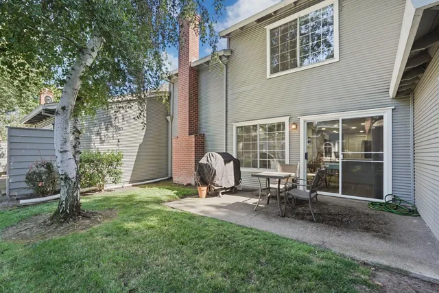 a backyard of a house with outdoor seating