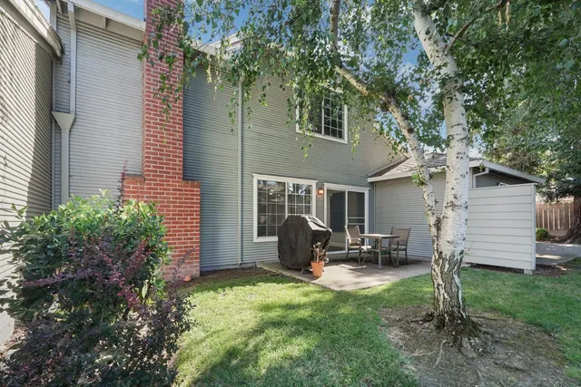 a view of a patio with table and chairs with wooden floor and fence